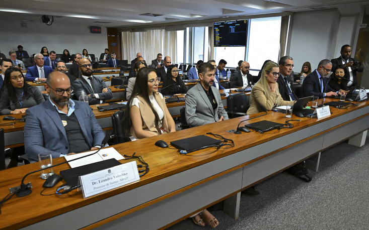 Attendees seated in rows in the meeting room.